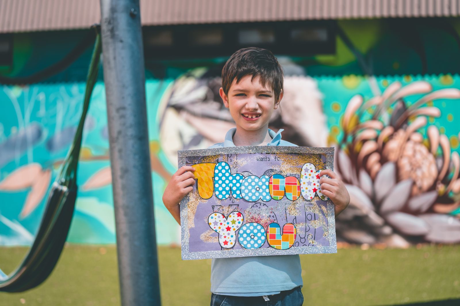 Student with a thank you sign for our supporters