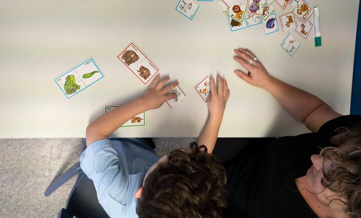 A student and teacher interact within a classroom at Aspect Hunter School