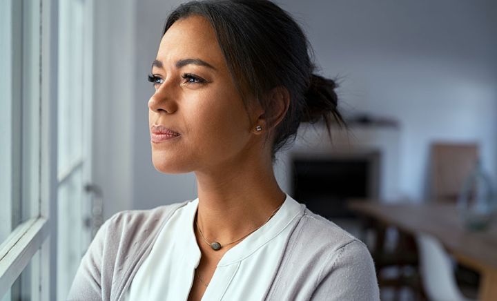 Woman deep in thought looking out window