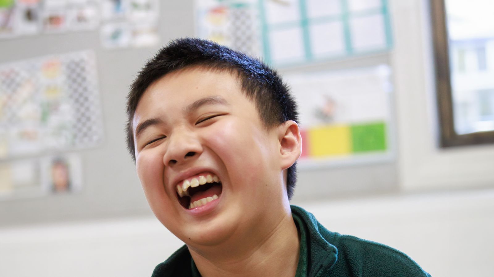 A student smiles with joy during classroom activites at Macarthur