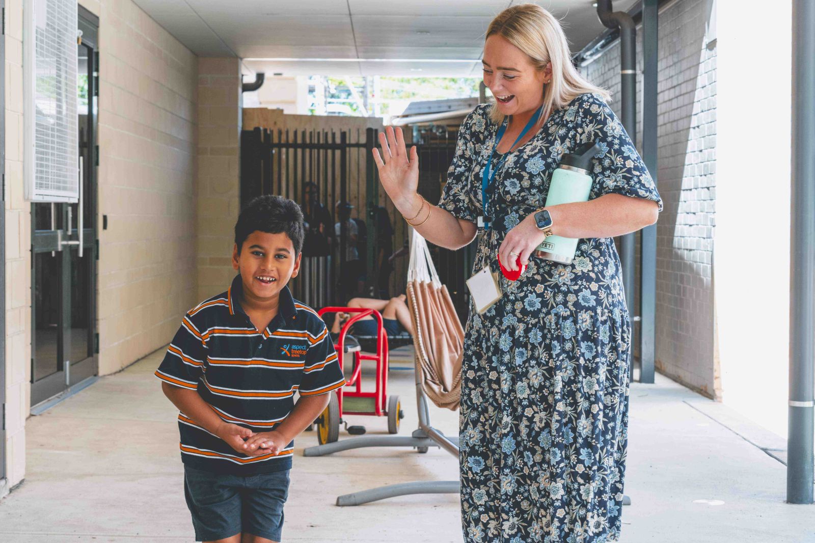 Student and teacher smiling