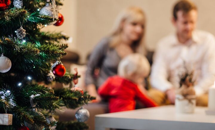 Family sitting together receiving donated christmas presents