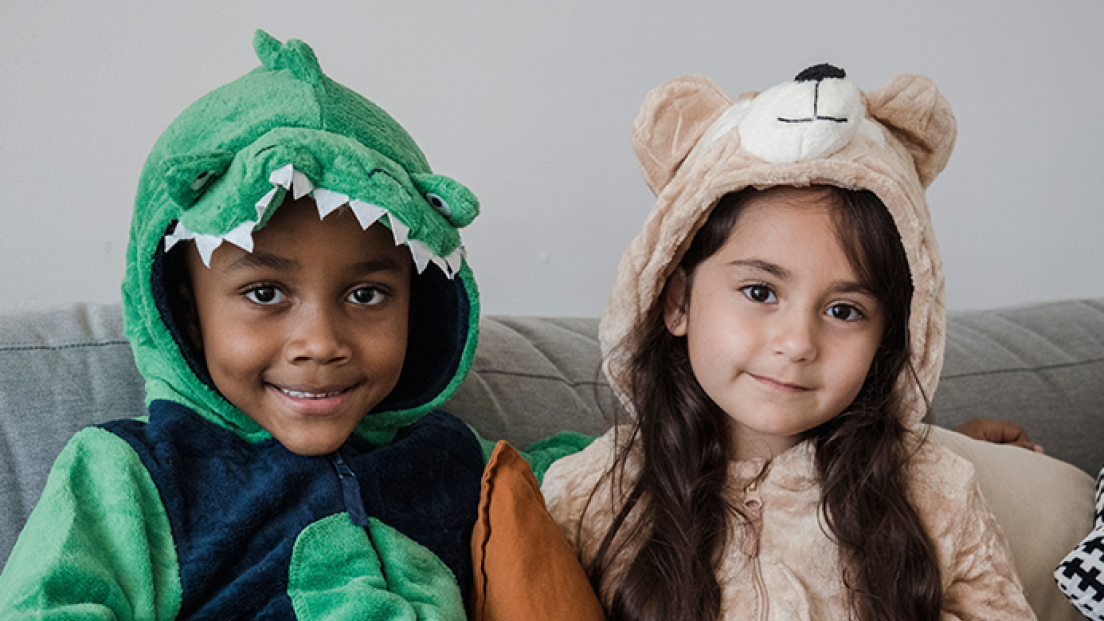 Two young children in onesies