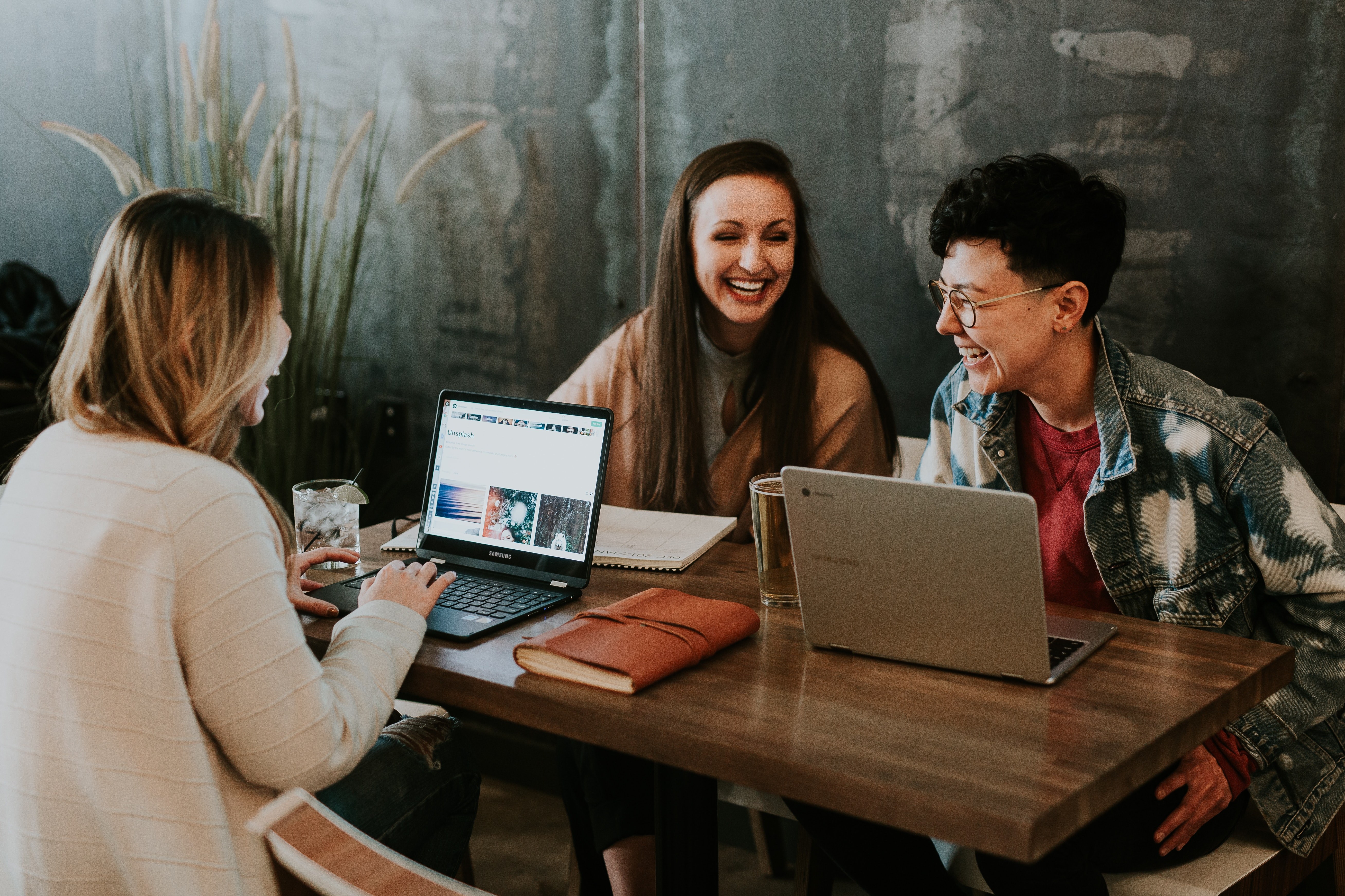 Women with laptops talking